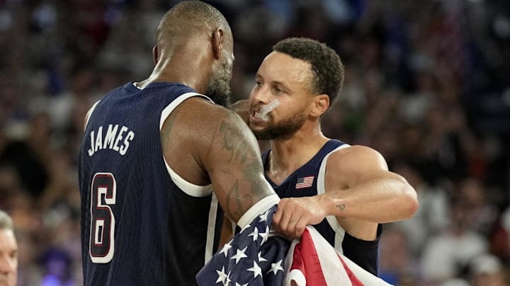 United States shooting guard Stephen Curry (4) and guard LeBron James (6) celebrate after defeating France in the men's basketball gold medal game during the Paris 2024 Olympic Summer Games.