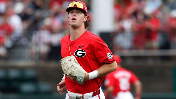 Georgia's Charlie Condon takes the field wearing a red jersey and black hat