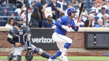 Jun 26, 2024; New York City, New York, USA;  New York Mets shortstop Francisco Lindor (12) hits a double in the first inning against the New York Yankees at Citi Field. 