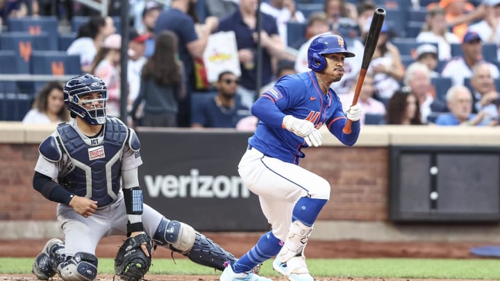Jun 26, 2024; New York City, New York, USA;  New York Mets shortstop Francisco Lindor (12) hits a double in the first inning against the New York Yankees at Citi Field. 