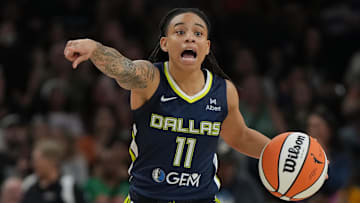 Jul 7, 2025; Phoenix, Arizona, USA; Dallas Wings guard JJ Quinerly (11) drives against the Phoenix Mercury in the first half at Footprint Center. Mandatory Credit: Rick Scuteri-Imagn Images