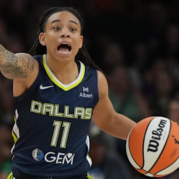 Jul 7, 2025; Phoenix, Arizona, USA; Dallas Wings guard JJ Quinerly (11) drives against the Phoenix Mercury in the first half at Footprint Center. Mandatory Credit: Rick Scuteri-Imagn Images