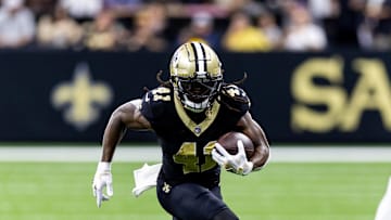 Sep 8, 2024; New Orleans, Louisiana, USA;  New Orleans Saints running back Alvin Kamara (41) runs against Carolina Panthers cornerback Jaycee Horn (8) during the first half at Caesars Superdome. 