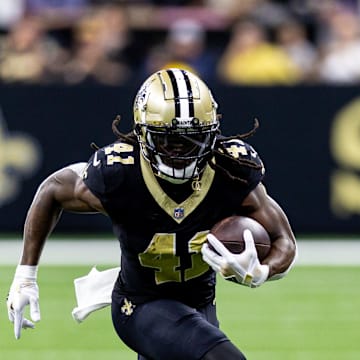 Sep 8, 2024; New Orleans, Louisiana, USA;  New Orleans Saints running back Alvin Kamara (41) runs against Carolina Panthers cornerback Jaycee Horn (8) during the first half at Caesars Superdome. 