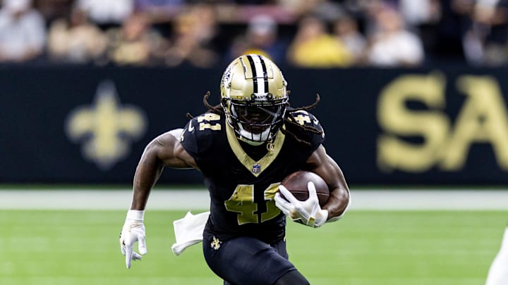 Sep 8, 2024; New Orleans, Louisiana, USA;  New Orleans Saints running back Alvin Kamara (41) runs against Carolina Panthers cornerback Jaycee Horn (8) during the first half at Caesars Superdome. 