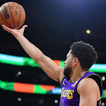 Feb 9, 2024; Los Angeles, California, USA; Los Angeles Lakers guard Skylar Mays (4) shoots against New Orleans Pelicans forward Brandon Ingram (14) during the first half at Crypto.com Arena. Mandatory Credit: Gary A. Vasquez-Imagn Images