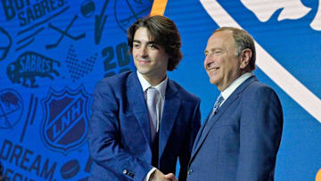 Matthew Savoie shakes hands with NHL commissioner Gary Bettman