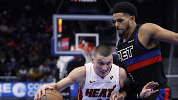 Nov 12, 2024; Detroit, Michigan, USA;  Miami Heat guard Tyler Herro (14) dribbles defended by Detroit Pistons forward Tobias Harris (12) in the first half at Little Caesars Arena.