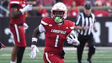 Louisville’s Isaac Brown runs the ball against Virginia at L&N Stadium Saturday.