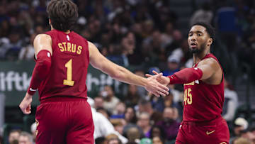 Jan 3, 2025; Dallas, Texas, USA;  Cleveland Cavaliers guard Donovan Mitchell (45) celebrates with Cleveland Cavaliers guard Max Strus (1) during the first half against the Dallas Mavericks at American Airlines Center. Mandatory Credit: Kevin Jairaj-Imagn Images