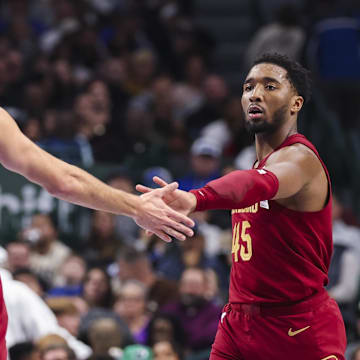 Jan 3, 2025; Dallas, Texas, USA;  Cleveland Cavaliers guard Donovan Mitchell (45) celebrates with Cleveland Cavaliers guard Max Strus (1) during the first half against the Dallas Mavericks at American Airlines Center. Mandatory Credit: Kevin Jairaj-Imagn Images