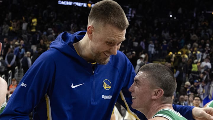 Feb 19, 2026; San Francisco, California, USA; Golden State Warriors center Kristaps Porzingis (left) shares a laugh with Boston Celtics guard Payton Pritchard (11) following their game at Chase Center. Mandatory Credit: D. Ross Cameron-Imagn Images