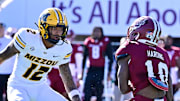 Oct 12, 2024; Amherst, Massachusetts, USA; Missouri Tigers cornerback Dreyden Norwood (12) looks to tackle Massachusetts Minutemen wide receiver T.Y. Harding (10) during the second half at Warren McGuirk Alumni Stadium. 