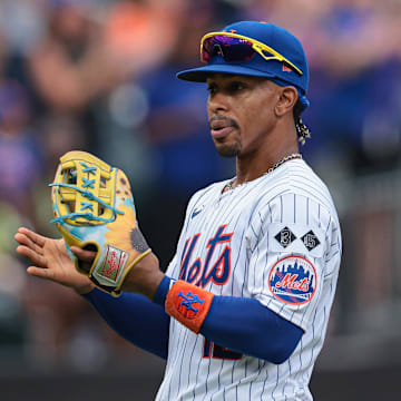 Aug 18, 2024; New York City, New York, USA; New York Mets shortstop Francisco Lindor (12) wears a special players weekend glove during the third inning against the Miami Marlins at Citi Field. Mandatory Credit: Vincent Carchietta-Imagn Images