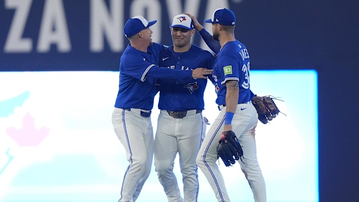 Sep 25, 2025; Toronto, Ontario, CAN; Toronto Blue Jays left fielder Anthony Santander (left) and center fielder Daulton Varsho (center) and right fielder Nathan Lukes (right) celebrate a win over the Boston Red Sox during the ninth inning at Rogers Centre. Mandatory Credit: John E. Sokolowski-Imagn Images
