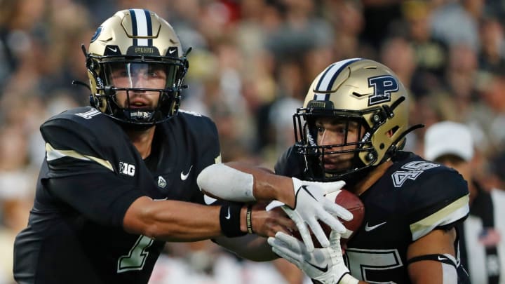 Purdue Boilermakers quarterback Hudson Card (1) hands the ball off to Purdue Boilermakers running back Devin Mockobee (45)