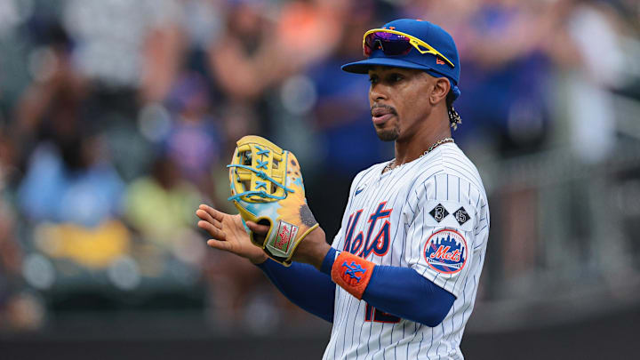 Aug 18, 2024; New York City, New York, USA; New York Mets shortstop Francisco Lindor (12) wears a special players weekend glove during the third inning against the Miami Marlins at Citi Field. Mandatory Credit: Vincent Carchietta-Imagn Images