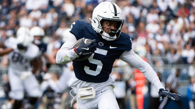 Penn State wide receiver Devonte Ross runs with the ball during the Blue-White Game at Beaver Stadium.