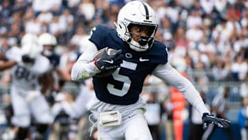 Penn State wide receiver Devonte Ross (5) runs with the ball during the Blue-White game at Beaver Stadium.