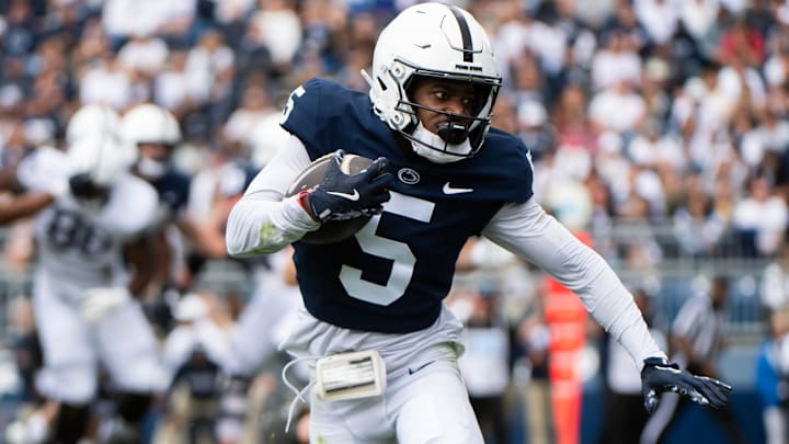 Penn State wide receiver Devonte Ross (5) runs with the ball during the Blue-White game at Beaver Stadium.