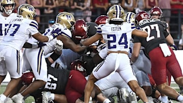 Sep 20, 2025; Pullman, Washington, USA; Washington Huskies running back Jordan Washington (4) leaps into the end zone for a touchdown against the Washington Huskies in the second half of Apple Cup at Gesa Field at Martin Stadium. Washington Huskies won 59-24. Mandatory Credit: James Snook-Imagn Images