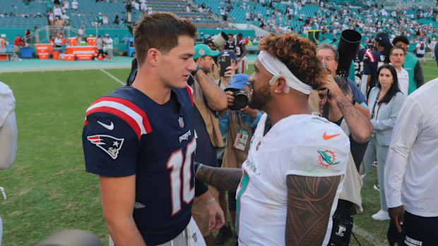 Nov 24, 2024; Miami Gardens, Florida, USA; New England Patriots quarterback Drake Maye (10) and Miami Dolphins quarterback Tu