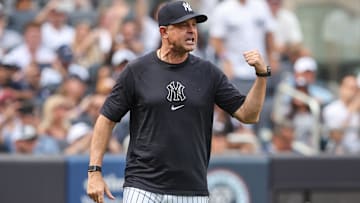 Sep 27, 2025; Bronx, New York, USA;  New York Yankees manager Aaron Boone (17) argues with first base umpire  Dan Iassogna (58) in the fifth inning against the Baltimore Orioles at Yankee Stadium. Mandatory Credit: Wendell Cruz-Imagn Images