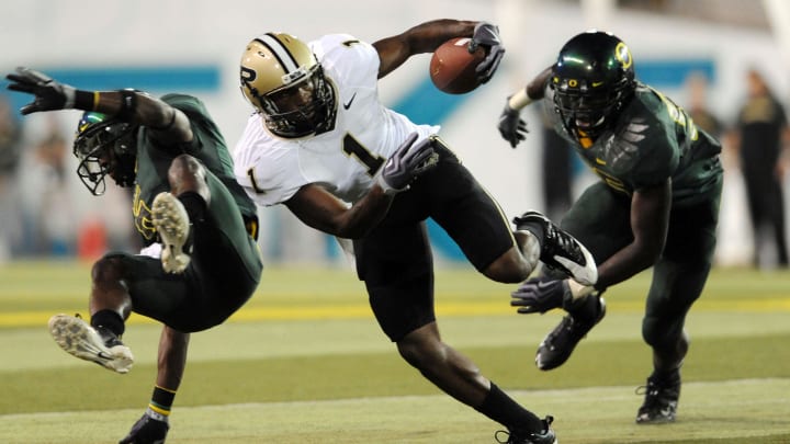 Sept 12, 2009; Eugene, OR, USA; Purdue Boilermakers wide receiver Keith Carlos (1) avoids the tackle of Oregon Ducks cornerback Walter Thurmond III (6) in the second quarter of the game at Autzen Stadium. 