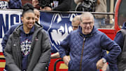 Apr 13, 2025; Hartford, CT, USA;   UConn Huskies head coach Geno Auriemma and UConn student-athlete Azzi Fudd smile at the crowd during the Final Four champions victory parade and rally outside of the XL Center in Hartford, CT. Mandatory Credit: Scott Rausenberger-Imagn Images