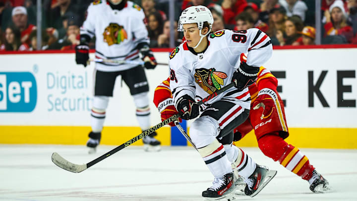 Dec 21, 2024; Calgary, Alberta, CAN; Chicago Blackhawks center Connor Bedard (98) controls the puck against the Calgary Flames during the third period at Scotiabank Saddledome. Mandatory Credit: Sergei Belski-Imagn Images