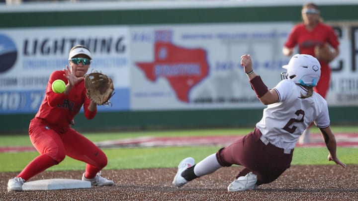 Calallen’s Kylie Butcher slides into second base while Veterans Memorial’s Jada Zepeda (left) looks to field a throw during a warm-up game at Calallen on April 22, 2025, in Corpus Christi.