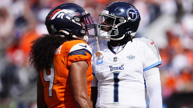 Tennessee Titans quarterback Cam Ward (1) and Denver Broncos safety Talanoa Hufanga (9) face off in the first half.