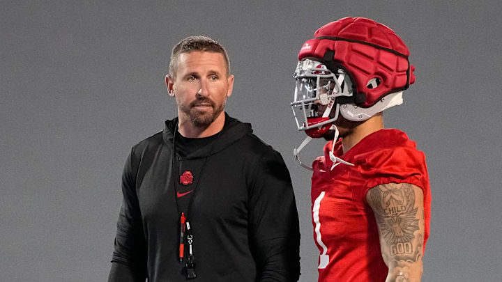 Ohio State Buckeyes offensive coordinator Brian Hartline talks to wide receiver Brandon Inniss (1) during spring football practice at the Woody Hayes Athletic Center on March 17, 2025.