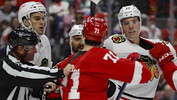 Jan 10, 2025; Detroit, Michigan, USA; Detroit Red Wings center Dylan Larkin (71) scuffles with Chicago Blackhawks defenseman Alex Vlasic (72) during the second period at Little Caesars Arena. Mandatory Credit: Brian Bradshaw Sevald-Imagn Images