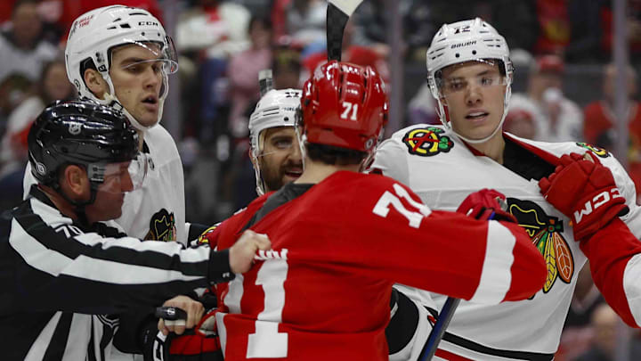 Jan 10, 2025; Detroit, Michigan, USA; Detroit Red Wings center Dylan Larkin (71) scuffles with Chicago Blackhawks defenseman Alex Vlasic (72) during the second period at Little Caesars Arena. Mandatory Credit: Brian Bradshaw Sevald-Imagn Images