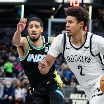 Mar 16, 2024; Indianapolis, Indiana, USA; Brooklyn Nets forward Cameron Johnson (2) dribbles the ball while Indiana Pacers guard Tyrese Haliburton (0) defends in the second half at Gainbridge Fieldhouse. Mandatory Credit: Trevor Ruszkowski-Imagn Images