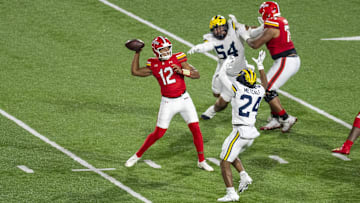 Maryland backup quarterback Khristian Martin throws under pressure from Michigan's Tevis Metcalf (24), defensive lineman Deyvid Palepale.