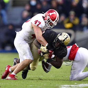 Purdue Boilermakers running back King Doerue (22) is tackled by Indiana Hoosiers linebacker Micah McFadden (47) and Indiana Hoosiers defensive back Marcelino McCrary-Ball (9) during the second quarter at Ross-Ade Stadium.