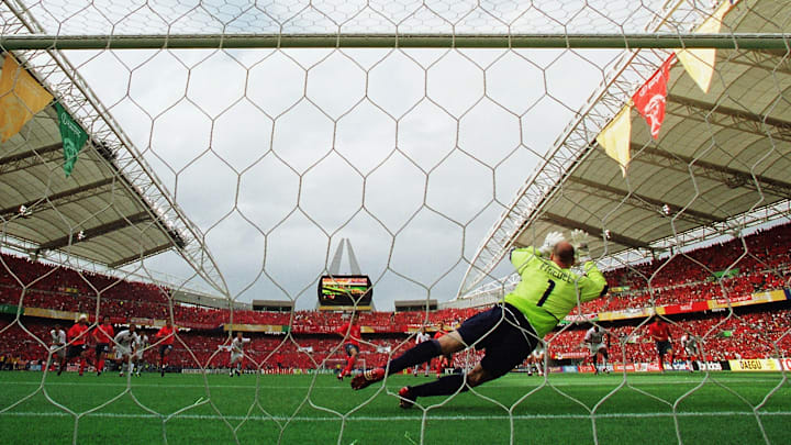 Brad Friedel of the USA saves a penalty from Eul Yong Lee of South Korea