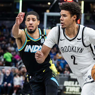 Mar 16, 2024; Indianapolis, Indiana, USA; Brooklyn Nets forward Cameron Johnson (2) dribbles the ball while Indiana Pacers guard Tyrese Haliburton (0) defends in the second half at Gainbridge Fieldhouse.