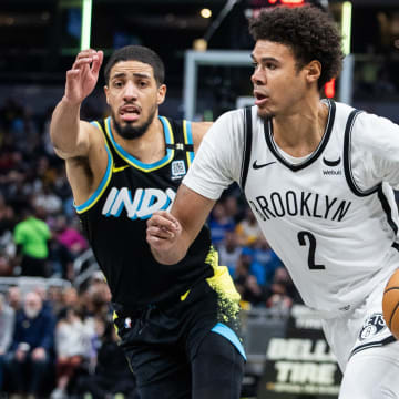 Mar 16, 2024; Indianapolis, Indiana, USA; Brooklyn Nets forward Cameron Johnson (2) dribbles the ball while Indiana Pacers guard Tyrese Haliburton (0) defends in the second half at Gainbridge Fieldhouse.