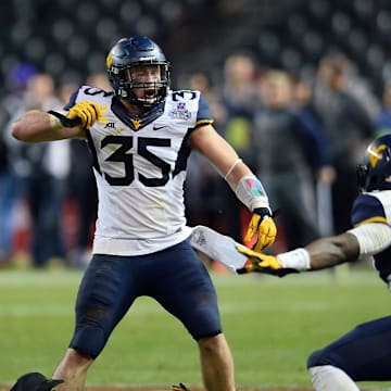 Jan 2, 2016; Phoenix, AZ, USA; West Virginia Mountaineers linebacker Nick Kwiatkoski (35) and  linebacker Shaq Petteway (36) celebrate a fourth down stop against the Arizona State Sun Devils during the second half of the 2016 Cactus Bowl at Chase Field. The Mountaineers won 43-42. Mandatory Credit: Joe Camporeale-Imagn Images