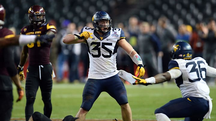 Jan 2, 2016; Phoenix, AZ, USA; West Virginia Mountaineers linebacker Nick Kwiatkoski (35) and linebacker Shaq Petteway (36) celebrate a fourth down stop against the Arizona State Sun Devils during the second half of the 2016 Cactus Bowl at Chase Field. The Mountaineers won 43-42. Mandatory Credit: Joe Camporeale-Imagn Images Jan 2, 2016; Phoenix, AZ, USA; West Virginia Mountaineers linebacker Nick Kwiatkoski (35) and linebacker Shaq Petteway (36) celebrate a fourth down stop against the Arizona State Sun Devils during the second half of the 2016 Cactus Bowl at Chase Field. The Mountaineers won 43-42. Mandatory Credit: Joe Camporeale-Imagn Images