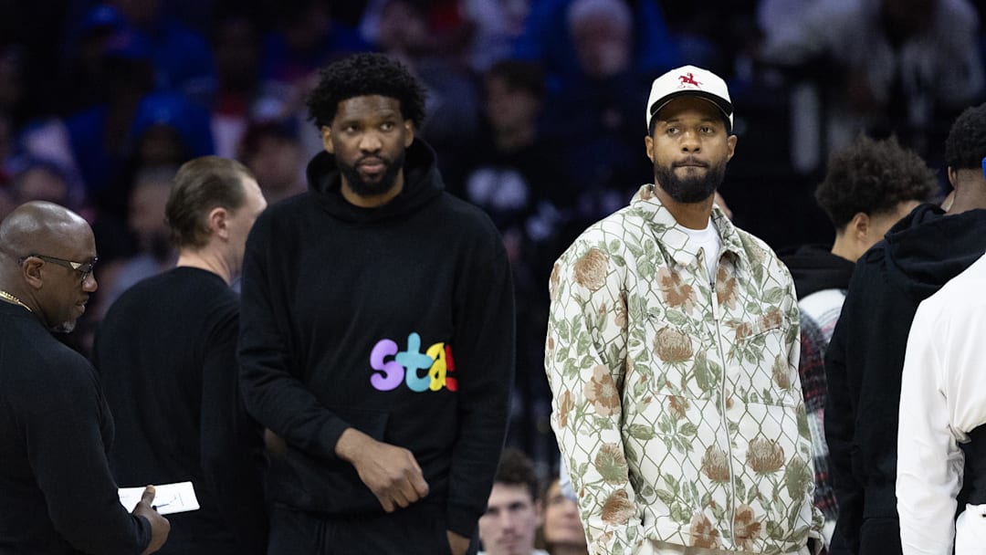 Nov 2, 2024; Philadelphia, Pennsylvania, USA; Injured Philadelphia 76ers Paul George (R) and Joel Embiid (L) look on during the first quarter against the Memphis Grizzlies at Wells Fargo Center. Mandatory Credit: Bill Streicher-Imagn Images
