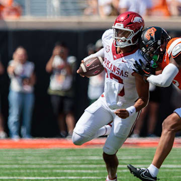 Sep 7, 2024; Stillwater, Oklahoma, USA; Arkansas Razorbacks quarterback Taylen Green (10) is hit by Oklahoma State Cowboys linebacker Jeff Roberson (22) during the third quarter at Boone Pickens Stadium. Mandatory Credit: William Purnell-Imagn Images