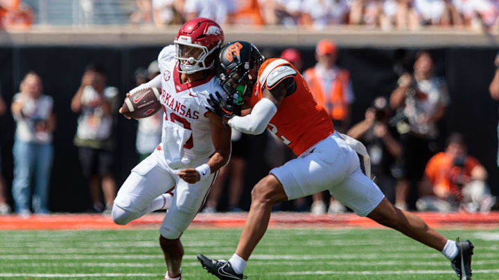 Sep 7, 2024; Stillwater, Oklahoma, USA; Arkansas Razorbacks quarterback Taylen Green (10) is hit by Oklahoma State Cowboys linebacker Jeff Roberson (22) during the third quarter at Boone Pickens Stadium. Mandatory Credit: William Purnell-Imagn Images