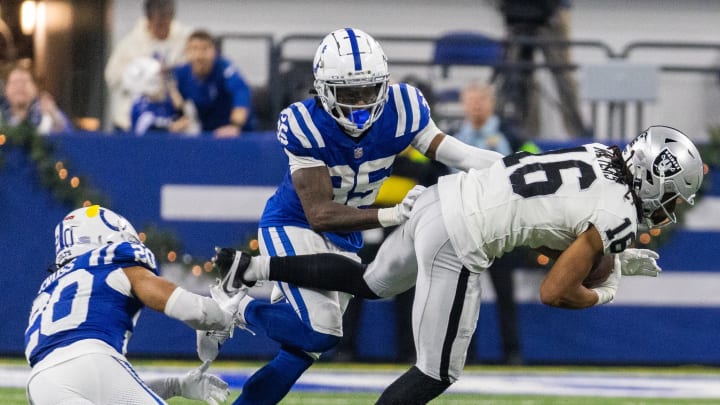 Dec 31, 2023; Indianapolis, Indiana, USA; Las Vegas Raiders wide receiver Jakobi Meyers (16) catches a ball while Indianapolis Colts safety Nick Cross (20) and cornerback Chris Lammons (35) defend in the second half at Lucas Oil Stadium. Mandatory Credit: Trevor Ruszkowski-USA TODAY Sports