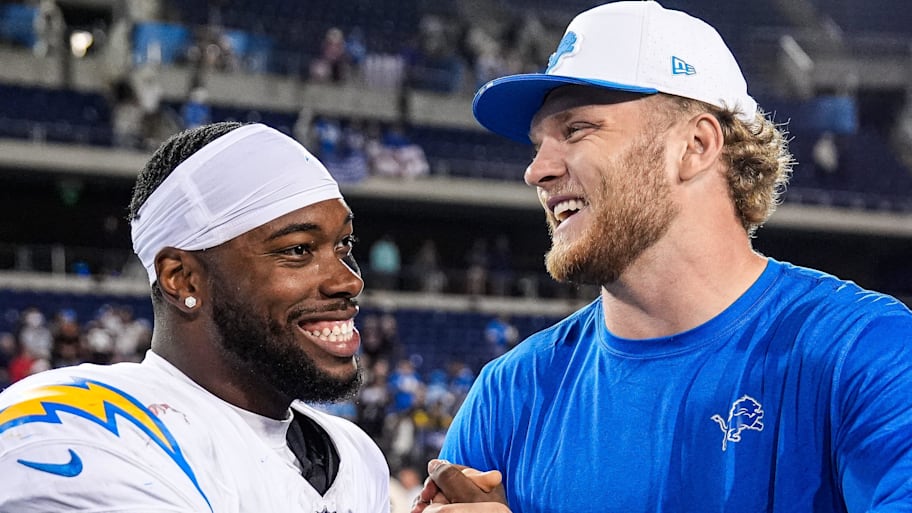 Detroit Lions defensive end Aidan Hutchinson (97) hugs LA Chargers running back Hassan Haskins (28)  | Junfu Han / USA TODAY NETWORK via Imagn Images