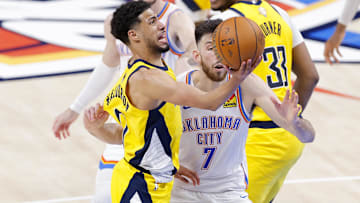 Indiana Pacers guard Tyrese Haliburton drives against Oklahoma City Thunder forward Chet Holmgren during the 2025 NBA Finals