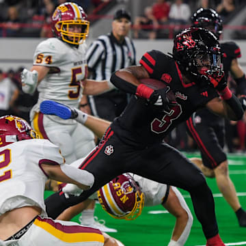 South Dakota running back Charles Pierre Jr. (3) charges through the Northern State defense on Thursday, Aug. 29, 2024, at the Dakota Dome in Vermillion, S.D.